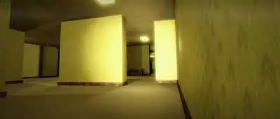 Identical yellow rooms lit by neon lights in The Backrooms
